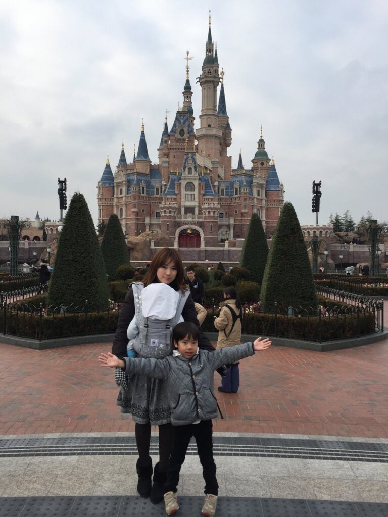上海ディズニーランドのEnchanted Storybook Castleを背景にした家族